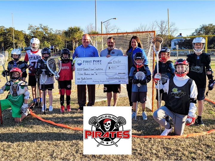 First Port City Bank Presents Check To The Amelia Island Pirates Youth Lacrosse Program
